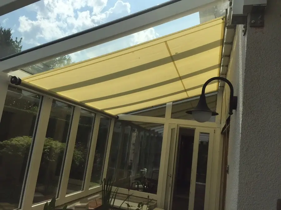 Angled patio shade providing shade from the sun to an outdoor living area.