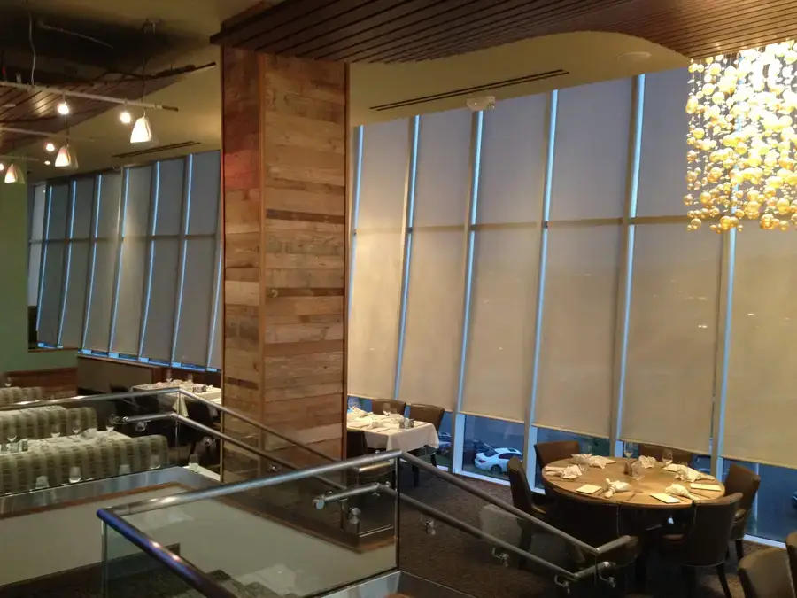 Angled roller shades amplifying the ambiance in an upscale restaurant.