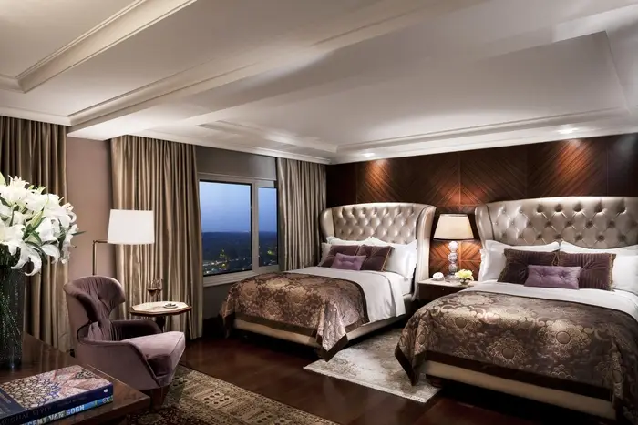 Two-bed bedroom in the Palace Suite. Drapery designed by BTX.
