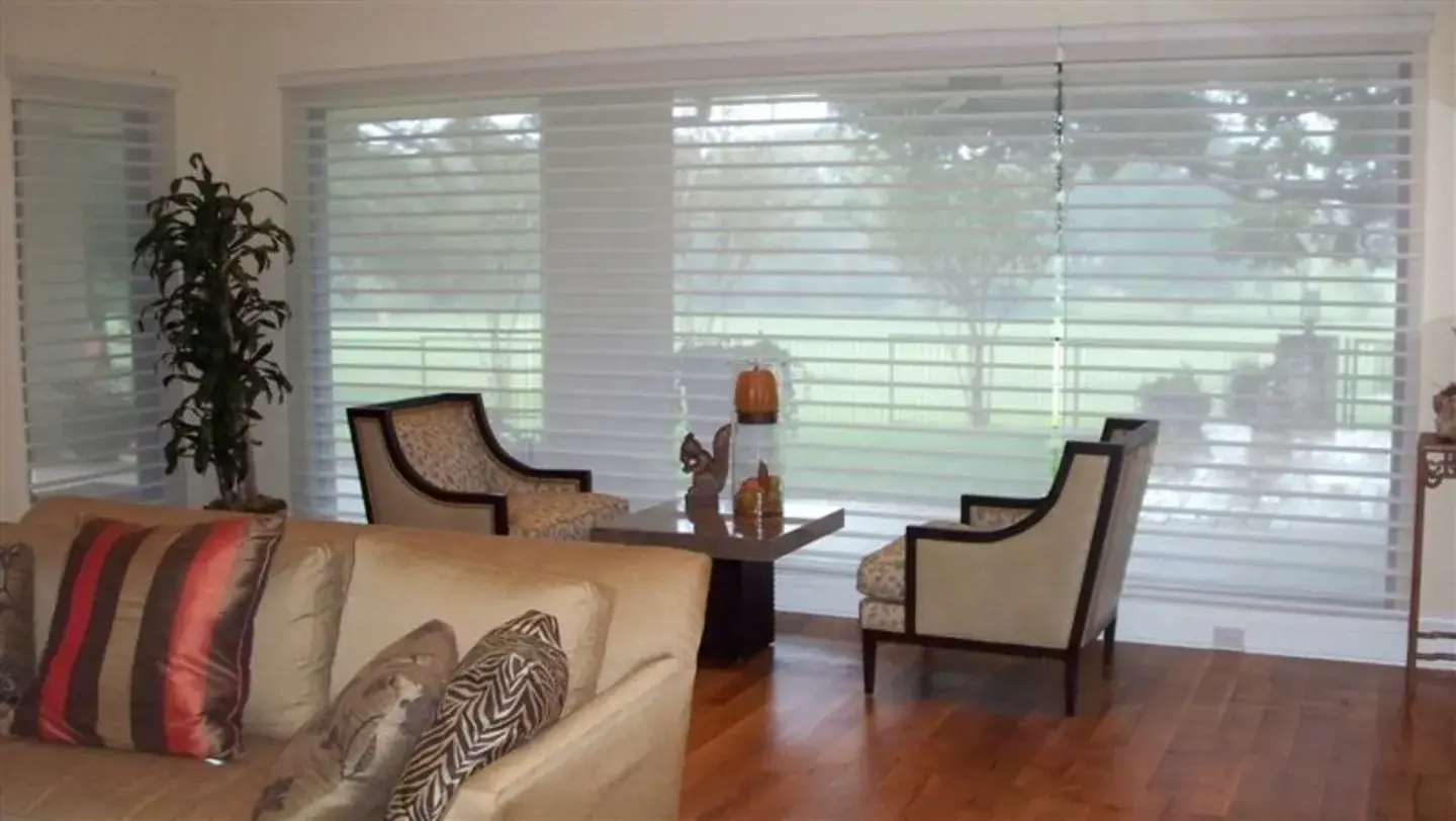 Fully-lowered Roman shades in a classically decorated living room.