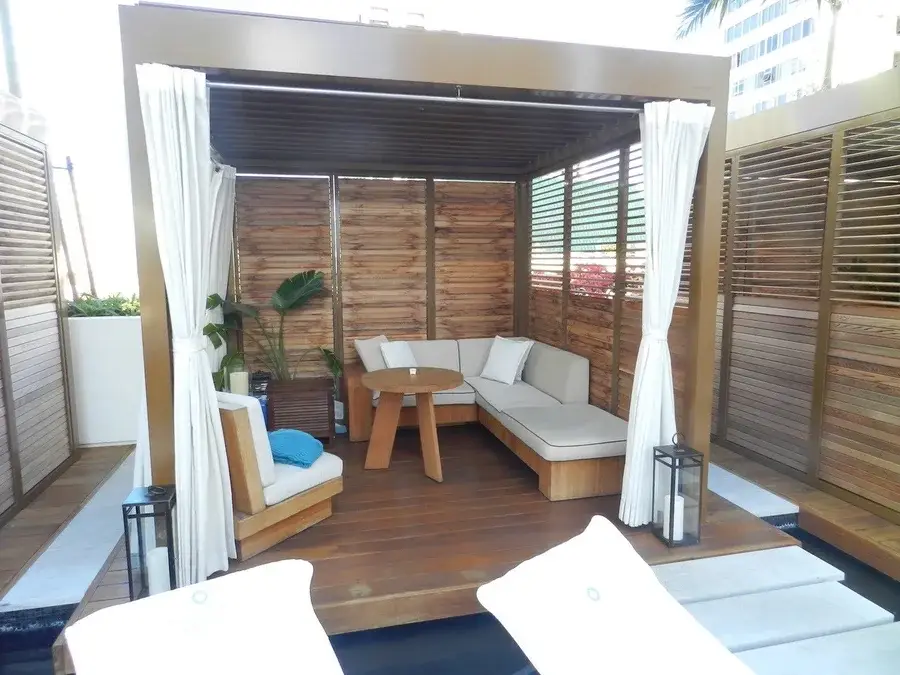 Close-up of an outdoor cabana in Hawaii with custom wooden shutters.
