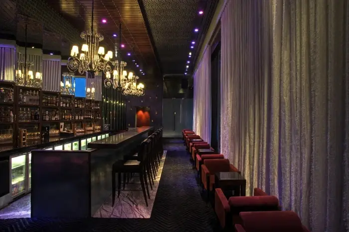 Sultry bar space with custom drapery built and designed by BTX.